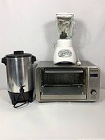 Front view of all three appliances: 30-cup party percolator, Oster blender on top of Cuisinart toaster oven