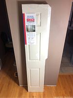 Full view of unopened Masonite six panel textured bifold door kit wrapped in plastic with label showing.