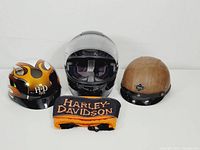 Overview of all items: three helmets and neck gaiter