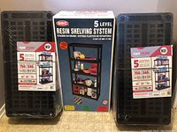 Two sealed GSC resin shelving system units in packaging next to box showing shelving system image and details.