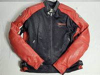 Front view of the 'Rocket' motorcycle jacket showing black mesh center and red perforated leather sleeves and shoulders.