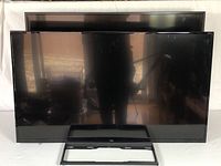 Front view showing two flat-screen TVs: Fire TV Edition in front and a second TV behind