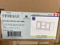Label on cardboard packaging showing dimensions and product details for JERCO Blue Shaker 2 door and 1 open niche upper wall cabinet for washer and dryer storage, 54" long, 16" deep, 24" high.