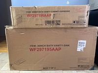 Two stacked cardboard boxes showing top labeled 36INCH BATH VANITY-CABINET-ESPRESSO WF297196AAP and bottom labeled 36INCH BATH VANITY-SINK WF297195AAP