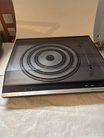 Full view of the Bang & Olufsen Beogram 3404 turntable with dust cover closed showing concentric platter design and overall condition.