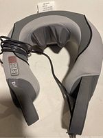 Full view of HoMedics gray neck massager showing shape and power cord