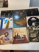 Photo showing 8 jazz vinyl LPs on a table with visible album covers by Jean-Luc Ponty, Terry Callier, Dave Grusin, and The Modern Jazz Quartet.