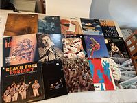 Top down photo showing full spread of 13 rock vinyl LP albums with various cover art