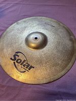 Top view of the 16-inch Solar by Sabian crash cymbal showing the logo and central mounting hole.