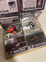 Photo of trading cards displayed in protective sleeves within an album, showing images of various trucks.