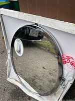 Round Tilt Mirror in box with clear reflective surface and metal frame.