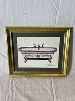 Framed watercolor painting of a Victorian clawfoot bathtub decorated with sea life elements, signed by Consuelo Gamboa.