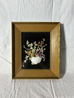 Framed vintage seashell miniature shadowbox showing the full front view, gold frame with black interior and seashell flower arrangement.