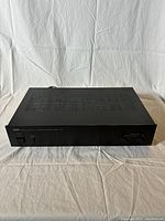 Top and slightly angled view of Yamaha M-35 amplifier showing ventilation slots and overall physical condition.