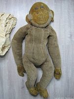 Full view of vintage Merry Thought monkey pyjama bag doll made of fabric, showing overall body, face details and worn condition.
