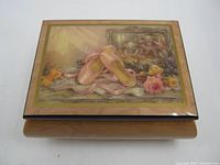 Top view of wooden music box with pink ballet slippers and teddy bears artwork on lid.