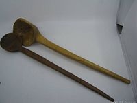 Both ladle spoons placed on white background, showing full length and shape difference.