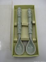 Two ceramic tea spoons in original packaging with light green glaze and sculpted Harubang handles.