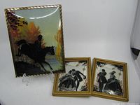 All three reverse painted silhouette pictures displayed together showing two smaller pieces with dancing couples and one larger equestrian scene.