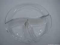 Top view of large divided serving dish with three sections, curved wave-like edges, and marked Villeroy & Boch on bottom