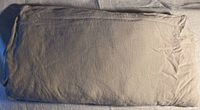 Folded grey linen duvet cover showing textured fabric and general color.