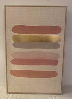 Front view showing abstract horizontal paint strokes in pink, gold, and beige on natural canvas with wood frame.