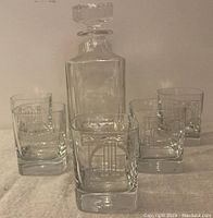 Photo of the decanter with stoppers alongside 5 whiskey glasses showing the style and size of the set.