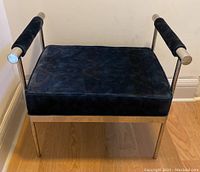 Front view showing blue velvet cushion and chrome legs