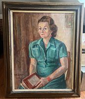 Full view of the oil painting depicting a woman seated, holding a frame, with signature visible.