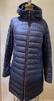 Front view of women's two-tone navy down jacket with hood and center front zipper