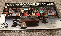 Original box showing Atari Video Computer System model CX-2600A with image of console and controllers on front.