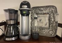 Overall lot view showing coffee maker, SodaStream machine with bottle, and seafood platter