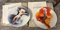 Two Marilyn Monroe collectible plates with original paperwork and shipping boxes, images showing front artwork.