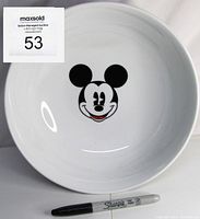 Photo of the white ceramic serving bowl showing the interior bottom with Mickey Mouse face design and a Sharpie pen for scale.