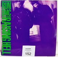 Front cover sleeve of Raising Hell vinyl LP showing album art with two band members and green text on purple background.
