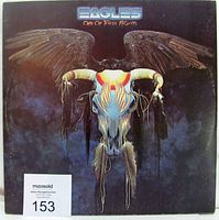 Front cover of The Eagles 'One Of These Nights' vinyl LP showing embossed 3D artwork of a bull skull with feathers and wings.