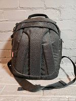 Front view of the black Manfrotto padded camera bag showing thick shoulder strap and handle.