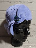 Front and side view of wool felt lavender lady's hat with decorative bow and jewel