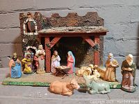 Overall photo showing the full nativity scene with stable and figures arranged