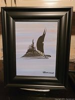 Framed original acrylic painting depicting a loon with tree silhouettes on its back, light blue and pale background.