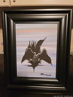 Framed original acrylic painting on board depicting a stylized loon with tree silhouettes within its wings, signed by Randy Knott, mounted in wide black frame.