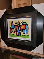 Full image of the framed art print showing the entire piece in a black frame with white corner protectors.