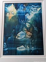 Close-up photo of deep blue abstract monoprint showing fluid shapes and color blending in blues and teals with some orange touches.