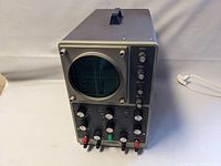 Front and top angle view of Heathkit Model 10-12 oscilloscope showing CRT screen and upper section with controls and handle.