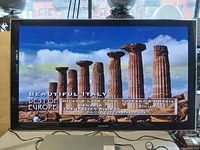 Samsung 58 inch plasma TV powered on showing "Beautiful Italy Best of Europe" travel video.