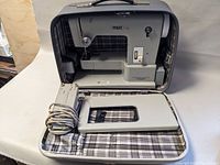 Pfaff 93 sewing machine in a hard carrying case with plaid lining, foot pedal and extension table placed in front.