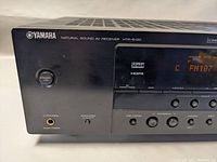 Close-up of front panel left side showing Yamaha branding, power standby button, and headphone jack.