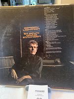 Back cover of the vinyl record showing Gordon Lightfoot sitting near a piano. Track list and personnel credits are visible.