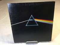 Front cover of Pink Floyd Dark Side of the Moon vinyl album showing iconic prism and rainbow design.