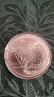 Close-up of the coin's reverse showing athlete, Montreal 1976, Olympic symbols and $10 denomination.